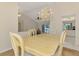 Elegant dining room featuring a chandelier and views of the pool area, adding a touch of luxury and brightness at 452 Greenwich Nw Ave, Port Charlotte, FL 33952