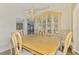 Charming dining room with a vintage display cabinet and chandelier, perfect for showcasing collectibles and Gathering heirlooms at 452 Greenwich Nw Ave, Port Charlotte, FL 33952