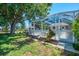Screened-in lanai showcasing outdoor living space and lush landscaping at 452 Greenwich Nw Ave, Port Charlotte, FL 33952