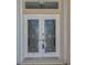Elegant double front doors with decorative glass and white trim, offering a grand entrance to the home at 452 Greenwich Nw Ave, Port Charlotte, FL 33952