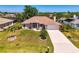 Charming single-story home with a well-manicured lawn, complemented by mature trees and a long driveway at 452 Greenwich Nw Ave, Port Charlotte, FL 33952