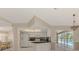 View of the kitchen featuring white cabinetry, black countertops, and decorative backsplash at 452 Greenwich Nw Ave, Port Charlotte, FL 33952