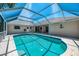 Inviting screened-in pool area with a bright blue pool and ample space for relaxation and entertainment at 452 Greenwich Nw Ave, Port Charlotte, FL 33952