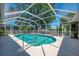 Refreshing screened-in pool with clear blue water and a surrounding patio, perfect for outdoor leisure at 452 Greenwich Nw Ave, Port Charlotte, FL 33952