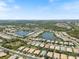 Wide aerial view of neighborhood, showcasing vast neighborhood, lakes, and many houses at 11663 Anhinga Ave, Venice, FL 34292