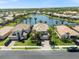 Stunning aerial view of a lakeside home with a tile roof, lush landscaping and a beautiful lake view at 11663 Anhinga Ave, Venice, FL 34292
