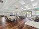 Spacious community room with wood floors, tables, chairs, and large windows at 11663 Anhinga Ave, Venice, FL 34292