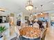 Cozy dining area with marble table, pendant lighting, and kitchen views at 11663 Anhinga Ave, Venice, FL 34292