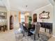 Elegant dining room with a dark wood table, upholstered chairs, and contemporary lighting at 11663 Anhinga Ave, Venice, FL 34292