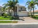 Charming two-story home featuring a brick paver driveway, two-car garage and manicured lawn at 11663 Anhinga Ave, Venice, FL 34292