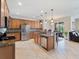 A spacious kitchen featuring stainless steel appliances, tile floors, ample cabinet space, and a breakfast bar at 11663 Anhinga Ave, Venice, FL 34292