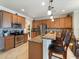 Open kitchen with granite countertops, stainless steel appliances, and breakfast bar seating at 11663 Anhinga Ave, Venice, FL 34292