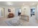 Open and airy loft area with neutral carpeting, decor table, and archways at 11663 Anhinga Ave, Venice, FL 34292