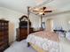 The main bedroom features a four poster bed, ceiling fan, and an arched entrance to the ensuite at 11663 Anhinga Ave, Venice, FL 34292