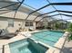 Relaxing screened-in pool with a spa, chaise lounges, and outdoor seating at 11663 Anhinga Ave, Venice, FL 34292