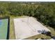 Aerial view showcasing the community's sand volleyball court and neighboring tennis court at 11663 Anhinga Ave, Venice, FL 34292