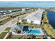 Aerial view of new homes with a pool, cabana, and lake view at 14204 Heritage Landing Blvd # 712, Punta Gorda, FL 33955