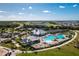 Aerial view of community amenities with a pool, clubhouse, and tennis courts at 14204 Heritage Landing Blvd # 712, Punta Gorda, FL 33955
