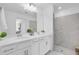 Bright bathroom featuring double vanity and glass enclosed shower for spa-like experience at 14204 Heritage Landing Blvd # 712, Punta Gorda, FL 33955