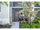 Ground floor condo entrance with private, screened in patio and lush landscaping around front walkway at 14204 Heritage Landing Blvd # 712, Punta Gorda, FL 33955