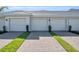 Attached garages with white doors, brick driveways, and grass accents at 14204 Heritage Landing Blvd # 712, Punta Gorda, FL 33955