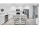 Bright, all white kitchen featuring stainless steel appliances, a spacious island, and tile flooring at 14204 Heritage Landing Blvd # 712, Punta Gorda, FL 33955