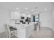 Clean, white kitchen with an island, stainless steel appliances, and ample counter space at 14204 Heritage Landing Blvd # 712, Punta Gorda, FL 33955
