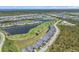 Aerial view of the community featuring well-maintained houses, lush landscaping, lakes, and a golf course at 14413 Heritage Landing Blvd, Punta Gorda, FL 33955