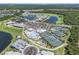 This aerial view showcases a community with pools, tennis courts, and lush landscaping, near golf courses and lakes at 14413 Heritage Landing Blvd, Punta Gorda, FL 33955