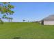 Expansive backyard with lush green lawn and picturesque views of the surrounding golf course at 14413 Heritage Landing Blvd, Punta Gorda, FL 33955