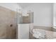 Bright bathroom with a soaking tub, tiled shower, and neutral finishes for a spa-like experience at 14413 Heritage Landing Blvd, Punta Gorda, FL 33955