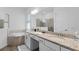 Primary bathroom with double granite vanity, large mirror, soaking tub, and access to the walk-in shower at 14413 Heritage Landing Blvd, Punta Gorda, FL 33955