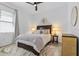Stylized bedroom with hardwood floors, ceiling fan, windows, and neutral decor at 14413 Heritage Landing Blvd, Punta Gorda, FL 33955