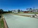 A view of the Bocce Ball Court with manicured landscaping and blue skies provides a relaxing atmosphere at 14413 Heritage Landing Blvd, Punta Gorda, FL 33955