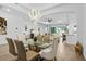 Bright, open-concept dining room with chandelier flows into the kitchen and living areas at 14413 Heritage Landing Blvd, Punta Gorda, FL 33955