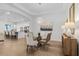 The dining room with a modern chandelier flows into the kitchen for seamless entertaining at 14413 Heritage Landing Blvd, Punta Gorda, FL 33955
