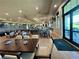 Upscale dining room featuring stylish seating, a full bar, and large windows with golf course views, ideal for socializing at 14413 Heritage Landing Blvd, Punta Gorda, FL 33955