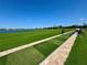 Scenic driving range with lush green fairways and views of the lake, perfect for golf enthusiasts and practice sessions at 14413 Heritage Landing Blvd, Punta Gorda, FL 33955