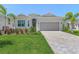 Beautiful single-story home featuring a well-manicured lawn, paved driveway, and a two-car garage at 14413 Heritage Landing Blvd, Punta Gorda, FL 33955