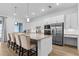 Well-lit kitchen with granite countertops, stainless steel appliances, and a spacious island with seating at 14413 Heritage Landing Blvd, Punta Gorda, FL 33955