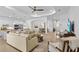 Bright, open-concept living room features a neutral color palette, modern furnishings, and seamless flow to the kitchen at 14413 Heritage Landing Blvd, Punta Gorda, FL 33955