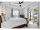 Bright main bedroom features a tray ceiling, wood floors, and access to the outdoor patio at 14413 Heritage Landing Blvd, Punta Gorda, FL 33955