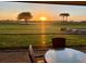 Sunset view from the outdoor patio seating area overlooking the lush golf course at 14413 Heritage Landing Blvd, Punta Gorda, FL 33955