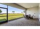 Screened patio with brick pavers, table and chairs and a beautiful view of the green lawn at 14413 Heritage Landing Blvd, Punta Gorda, FL 33955