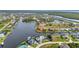 Community aerial view of waterfront homes along a canal with private docks and lush landscaping at 15490 Seafoam Cir, Port Charlotte, FL 33981