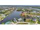 Expansive aerial shot featuring numerous homes nestled along canals in a vibrant waterfront community at 15490 Seafoam Cir, Port Charlotte, FL 33981