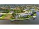 A waterfront community featuring custom homes with canals, boat docks, and tropical landscaping at 15490 Seafoam Cir, Port Charlotte, FL 33981