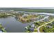 An aerial view showcases homes along canals, creating a serene and picturesque waterfront community at 15490 Seafoam Cir, Port Charlotte, FL 33981