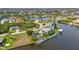 Waterfront living showcased in an aerial view, featuring a pool and private dock along the serene canal at 15490 Seafoam Cir, Port Charlotte, FL 33981