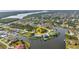 Aerial view showcasing a waterfront property with a private dock, located on a serene canal at 15490 Seafoam Cir, Port Charlotte, FL 33981